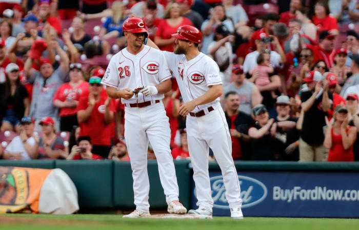 Cincinnati Reds first base coach Collin Cowgill (right) reacts with pinch hitter TJ Hopkins during a game. (2023)